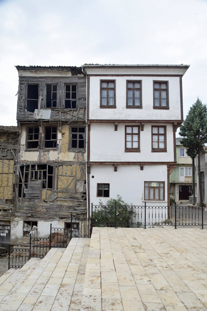 A building with a balcony and stairs in front of it